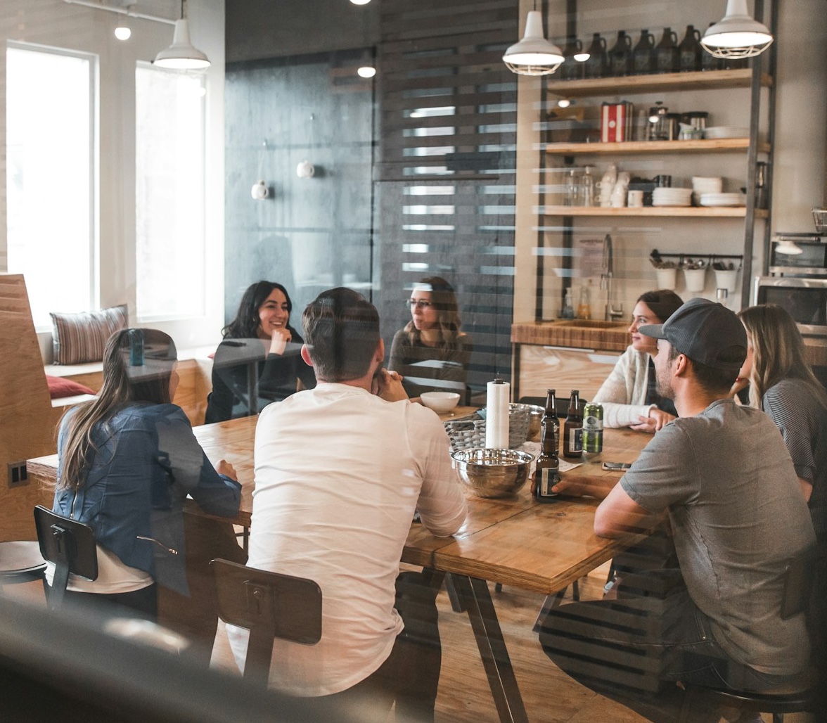 People gathered around a table in real conversation